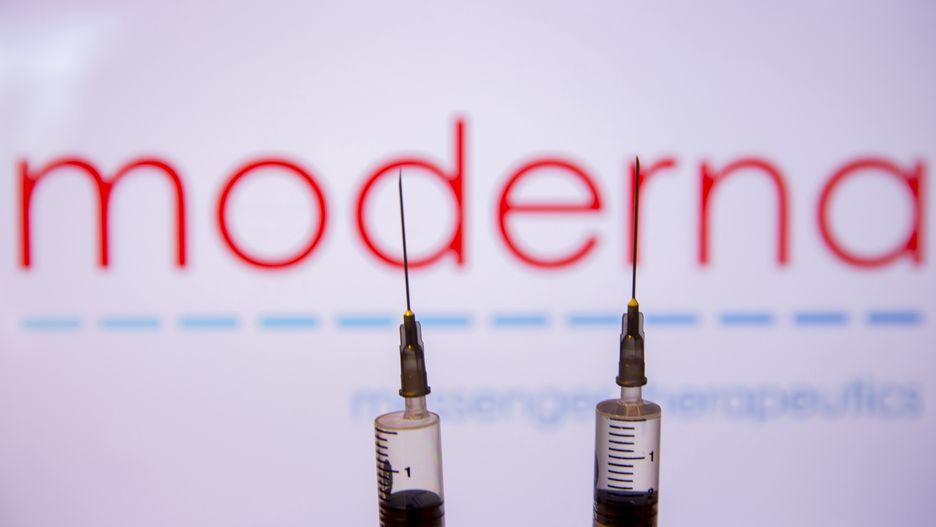 ANKARA, TURKEY - NOVEMBER 16: In this photo illustration, a laptop screen displays logo of the Moderna biotechnology company and syringes are seen in front of the screen in Ankara, Turkey on November 16, 2020. A candidate COVID-19 vaccine of American Moderna biotechnology company appears to be 94.5% effective against the novel coronavirus. (Photo by Emin Sansar/Anadolu Agency via Getty Images)