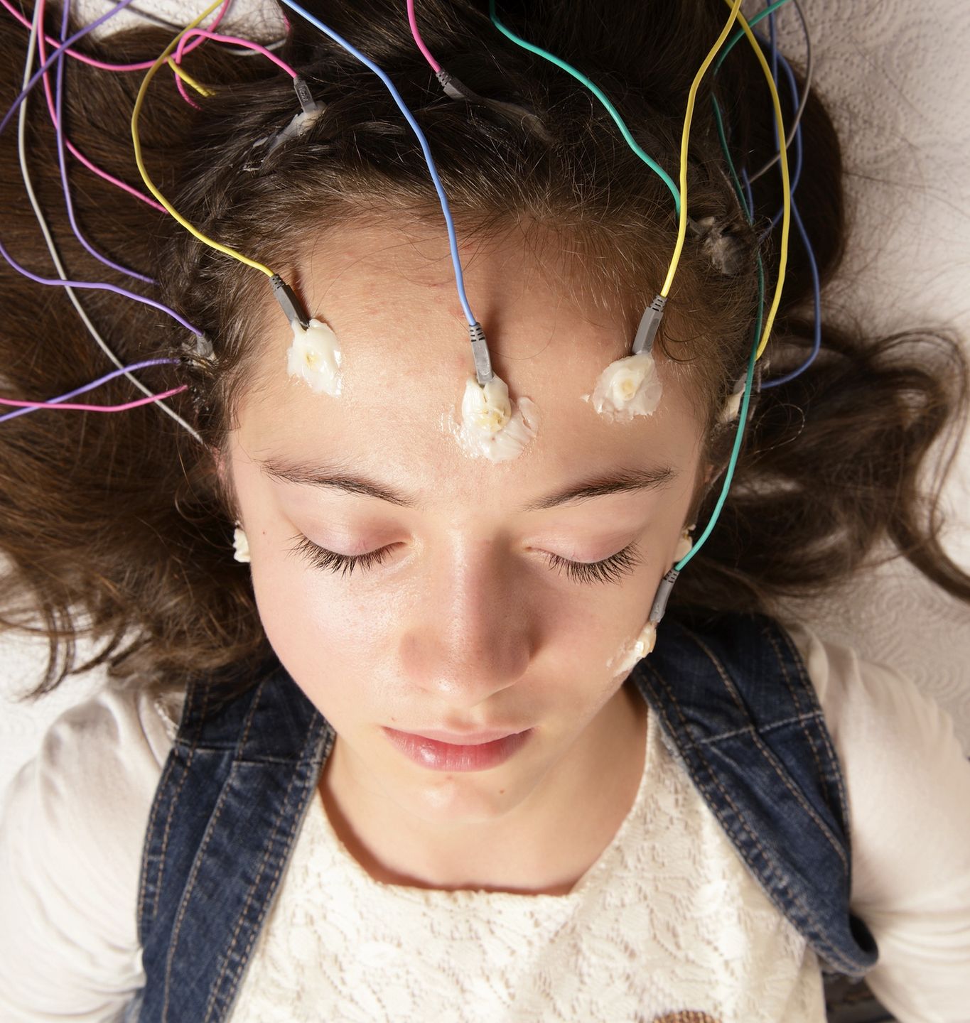 ElectroencephalographyActual Electroencephalography (EEG) recording net being used on a young girl. EEG is the recording of the brain's spontaneous electrical activity over a short period of time.fmajorSensor, Mental Health, Real People, Service, Young Women, Women, Females, Human Nervous System, Patience, Wave Pattern, Clinic, Epilepsy, Eyes Closed, Electrode, Neurosurgery, Human Scalp, Pediatrician, Medical Exam, Scientific Experiment, Child, Lying Down, Examining, Looking, Sleeping, Caucasian Ethnicity, One Person, Control, Exploration, Care, Healthcare And Medicine, Science, Research, Indoors, Vertical, Human Head, Human Brain, Illness, Patient, People, Hospital, Cable, Medicine, EEG, Medical Equipment, Power Line, Equipment, neuroscience, Hospital Bed, Neurological Examination