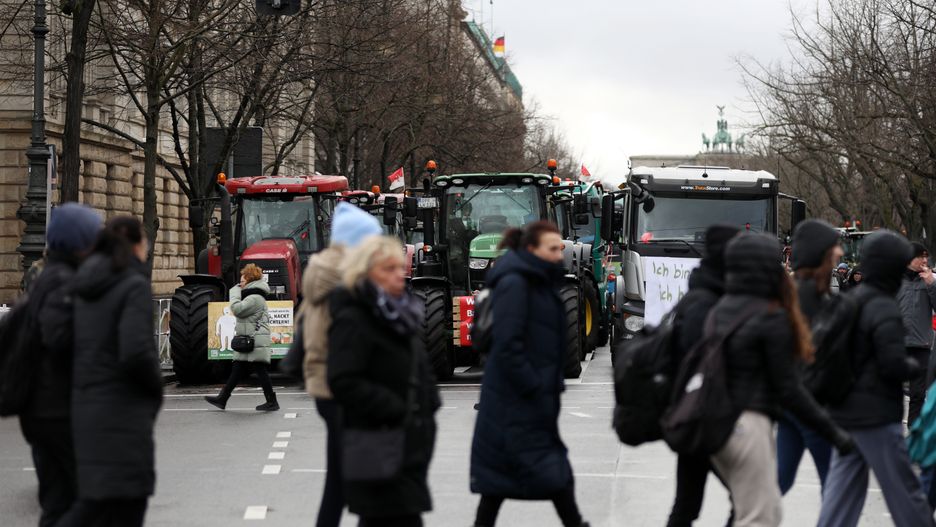 BERLIN, GERMANY - JANUARY 15: Tractors block the street while farmers protest in a large-scale demonstration on January 15, 2024 in Berlin, Germany. Farmers have been protesting across Germany for over a week against proposed government measures that would reduce federal benefits for the agricultural sector. While the coalition government recently stepped back from some of the measures, including proposed taxation of agricultural vehicles and cutting agricultural fuel subsidies, farmers have vowed to press on with their protests in order to stop any measures from being enacted at all. The government is seeking to save EUR 100 million in its agriculture budget. (Photo by Maryam Majd/Getty Images)