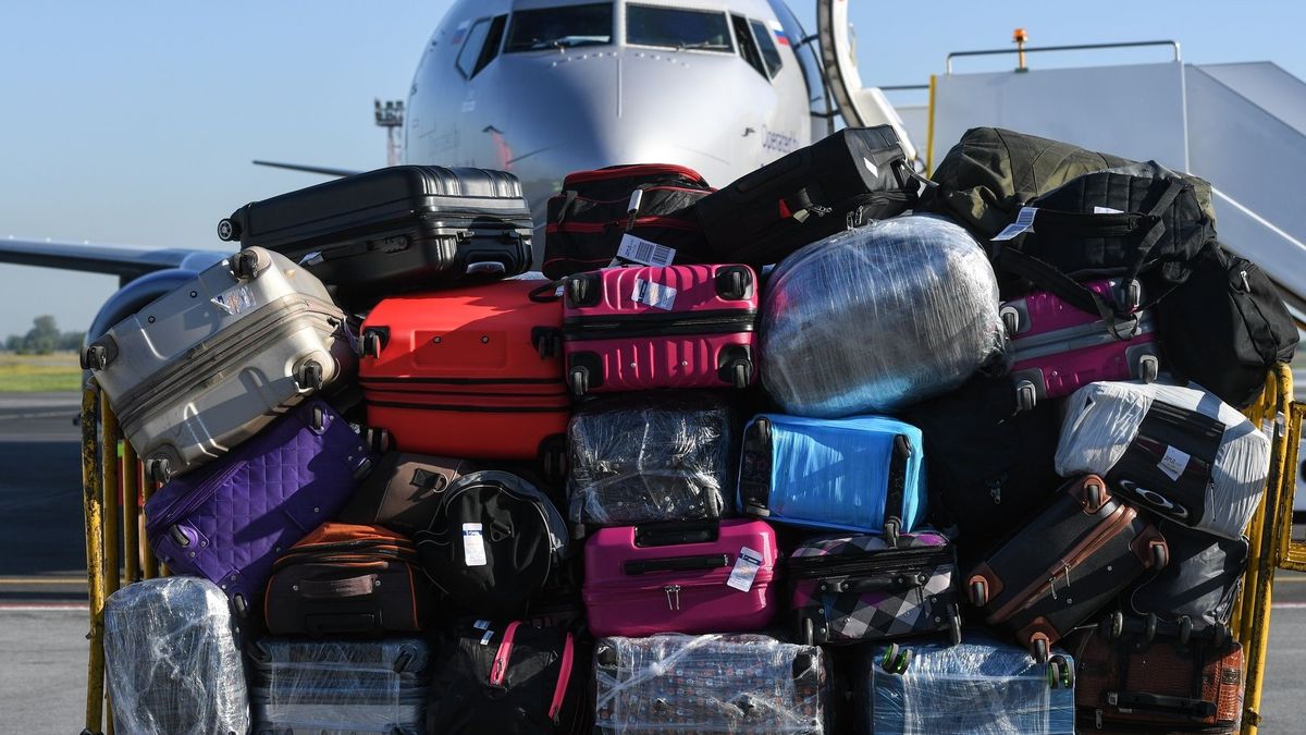Traveler waiting for a travel bag on the belt in airport after arrival to airport destination flight
