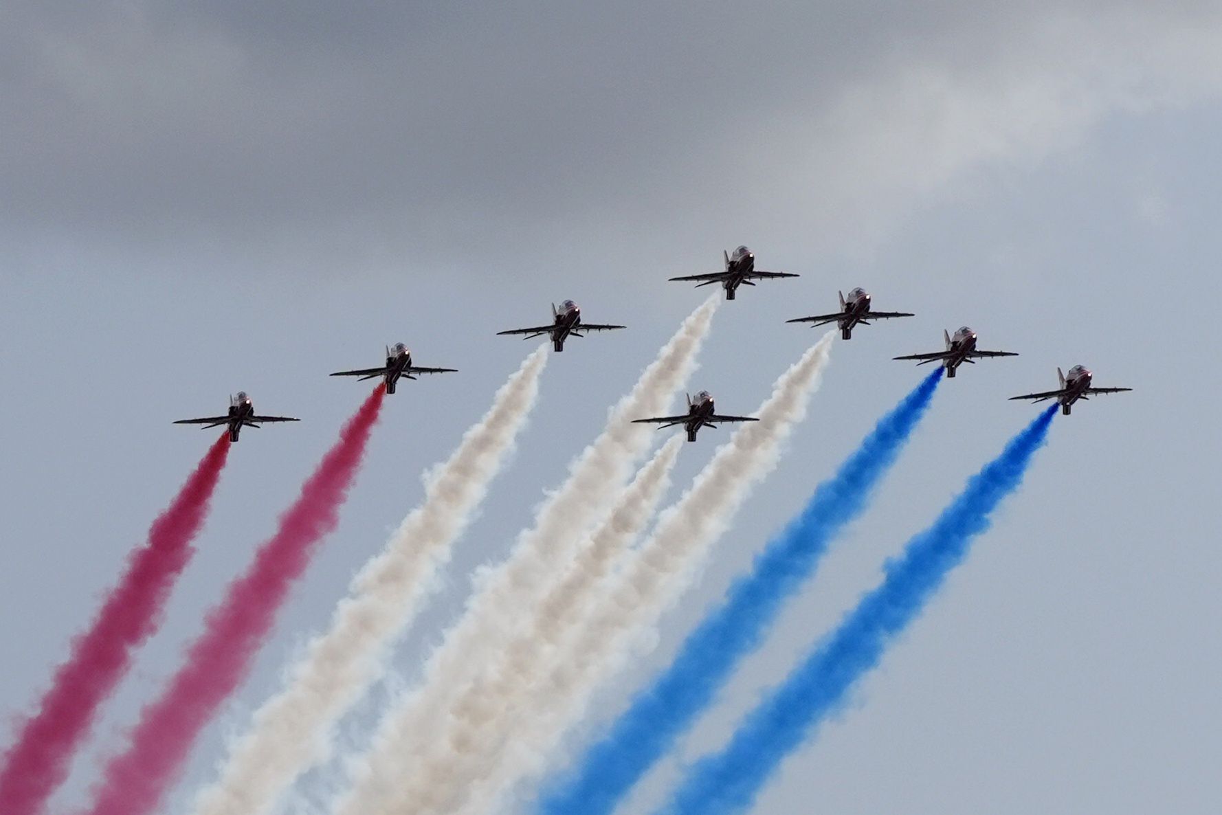 ALREWAS, ENGLAND - AUGUST 15: The Red Arrows flypast seen from at the Far East Corner of the National Memorial Arboretum, during a reception for VJ veterans and their families hosted by the Royal British Legion at The Aspects Building, following a national Service of Remembrance to mark the 80th Anniversary of VJ Day at the National Memorial Arboretum in Alrewas, Staffordshire on August 15, 2025, In Alrewas, England. The service commemorates the 80th Anniversary of Victory over Japan Day, or VJ Day, which marks the announcement of Japan's acceptance of the terms of the Potsdam Declaration on August 15, 1945, effectively bringing WWII to an end. (Photo by Danny Lawson - WPA Pool/Getty Images)