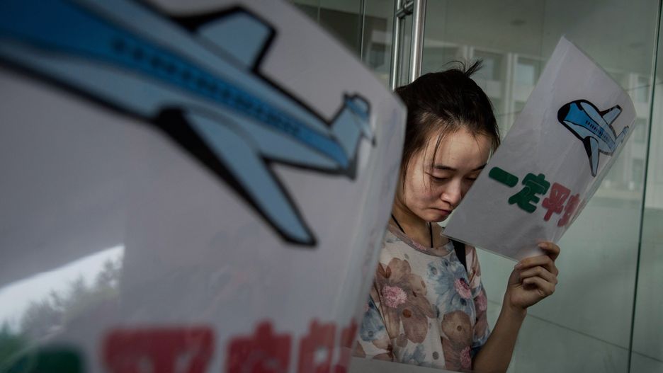 Chinese Relatives React To MH370 NewsBEIJING, CHINA - AUGUST 06: A Chinese relative of a missing passenger on Malaysia Airlines flight MH 370 weeps as she and others wait for information outside the airline's office on August 6, 2015 in Beijing, China. Malayasia's Prime Minister announced on Thursday that a piece of wing discovered washed up on Reunion Island last week is from Malaysia Airlines Flight MH 370 which vanished on March 8, 2014 when it was travelling from Kuala Lumpur to Beijing, possibly bringing to an end one of modern aviation's greatest mysteries. Officials and experts from other countries including the United States and Australia have been more cautious, saying that more investigating needs to be done.  (Photo by Kevin Frayer/Getty Images)Kevin Frayer