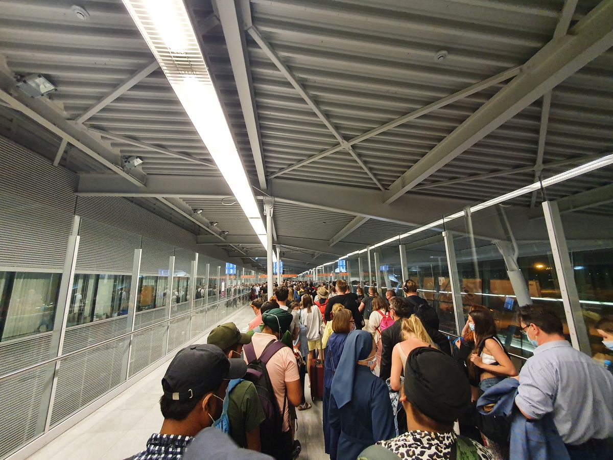 Setki osób w korytarzu na lotnisku w Warszawie. Kilkadziesiąt minut oczekiwania 