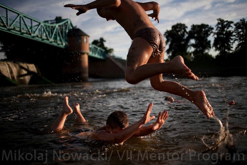 Children play in Odra river under Bartoszowicki weir, Wroclaw, Poland on Jul. 13, 2010.