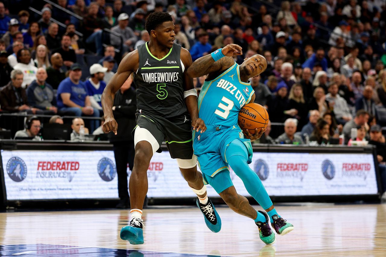 MINNEAPOLIS, MINNESOTA - JANUARY 22: Terry Rozier #3 of the Charlotte Hornets drives to the basket against Anthony Edwards #5 of the Minnesota Timberwolves in the third quarter at Target Center on January 22, 2024 in Minneapolis, Minnesota. The Hornets won 128-125. NOTE TO USER: User expressly acknowledges and agrees that, by downloading and or using this photograph, User is consenting to the terms and conditions of the Getty Images License Agreement. (Photo by David Berding/Getty Images)