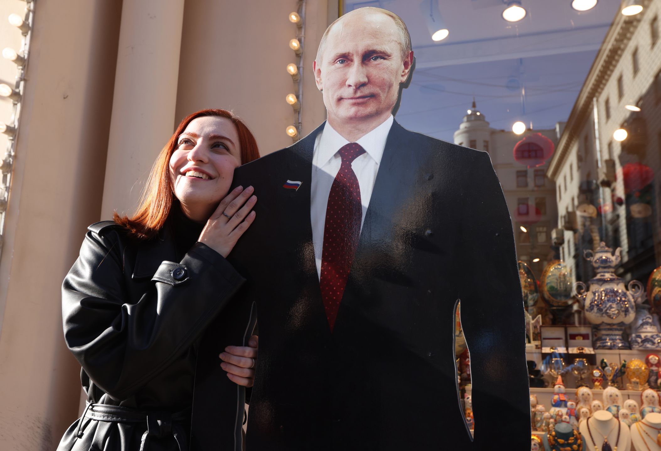 Russia Prepares For The Presidential ElectionsMOSCOW, RUSSIA - MARCH 14: (RUSSIA OUT) A woman poses for a photo beside a full-length cardboard cut-out of President Vladimir Putin at a souvenir shop ahead of the upcoming elections for the President of Russia on March 14, 2024 in Moscow, Russia. Russian President Vladimir Putin is expected to win the 2024 Presidential Elections, planned on March 15-17. (Photo by Contributor/Getty Images)Contributor