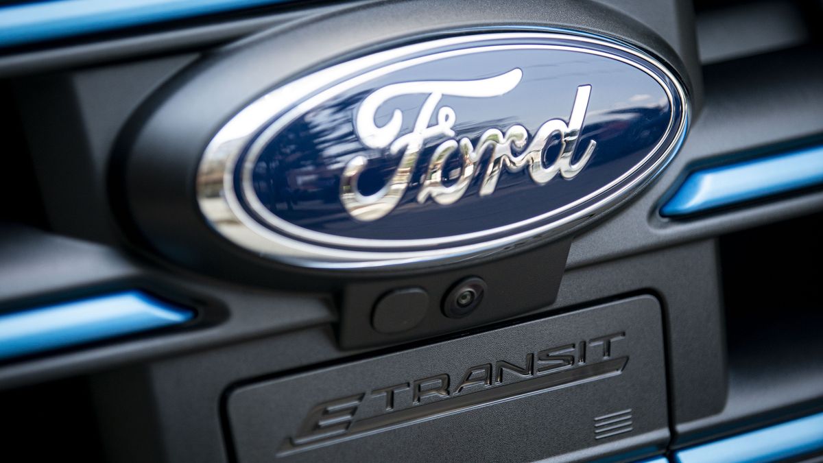 The badge of a Ford Motor Co. E-Transit electric vehicle during a presentation in Washington, D.C., U.S., on Wednesday, July 28, 2021. This year Ford's chief executive officer boosted his company's bet on plug-in models by more than a third, to $30 billion, and promising to electrify virtually the entire lineup. Photographer: Al Drago/Bloomberg via Getty Images