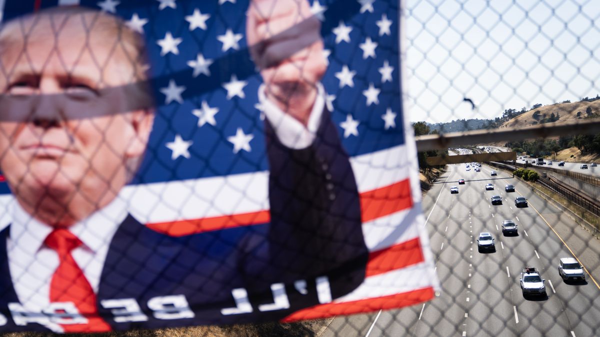 A Donald Trump-themed flag hangs over a Highway 24 overpass in Lafayette, Calif., Sunday, July 14, 2024. (Photo by Minh Connors/San Francisco Chronicle via Getty Images)