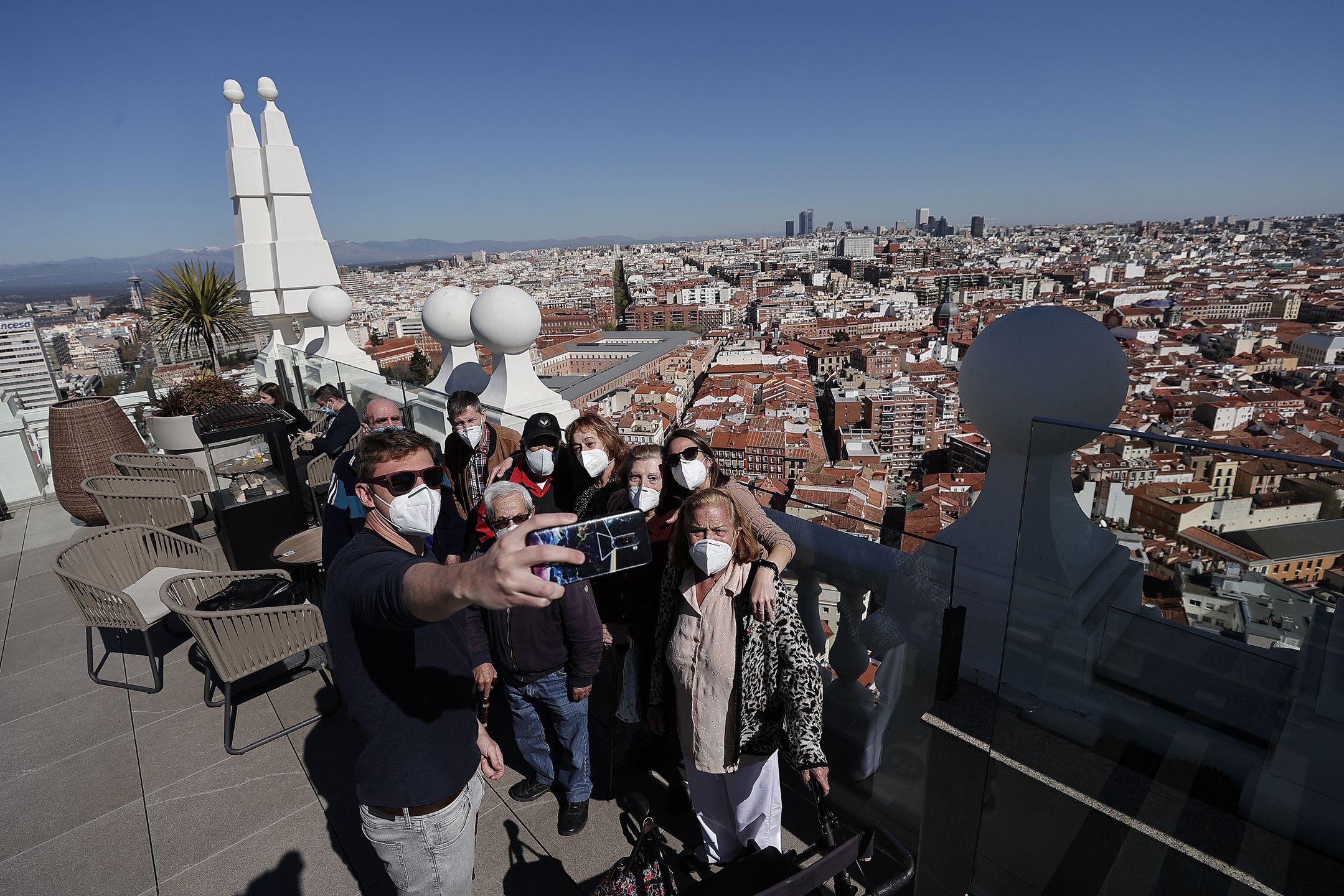 MADRID, SPAIN - MARCH 15: Elderly people who received Covid-19 vaccines enjoy the scenery of the city from the observation deck of a hotel in Madrid, Spain on March 15, 2021. Special event organized to give morale to the elderly people who are over 80 years who were most affected by the pandemic. (Photo by Burak Akbulut/Anadolu Agency via Getty Images)