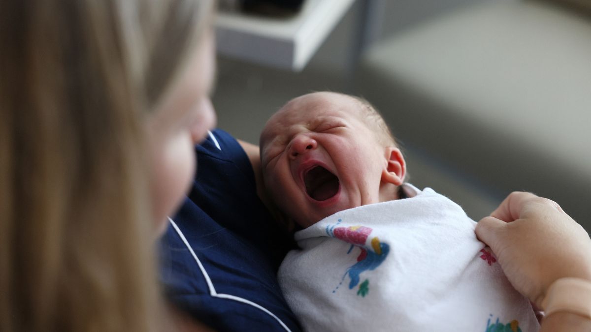 Concord, MA - July 28: A newborn baby boy yawns as he sits with his mother at Emerson Hospital. Births rebounded to pre-pandemic levels in Massachusetts, rising 4 percent in 2021 after plummeting by the same margin in 2020, according to new data from the National Center for Health Statistics. (Photo by Jessica Rinaldi/The Boston Globe via Getty Images)