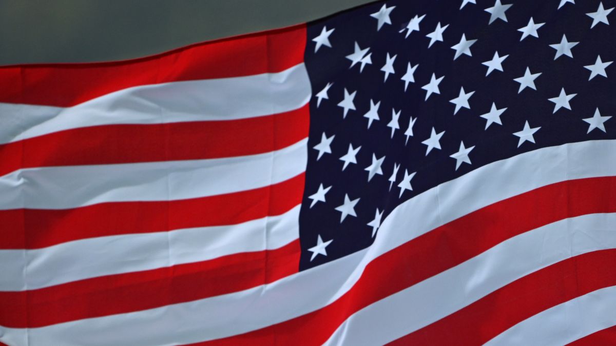 STELLENBOSCH, SOUTH AFRICA - OCTOBER 14: A flag bearer holds the flag of the United States during the National Anthems prior to the WXV 2 Match between United States and Samoa at The Danie Craven Stadium on October 14, 2023 in Stellenbosch, South Africa. (Photo by Johan Rynners - World Rugby/World Rugby via Getty Images)