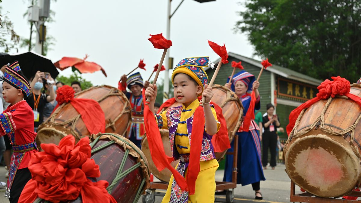 NANNING, CHINA - APRIL 21: A child beats a drum during an activity to welcome Sanyuesan Festival on April 21, 2023 in Nanning, Guangxi Zhuang Autonomous Region of China. The Sanyuesan Festival falls on the third day of the third lunar month. (Photo by Yu Jing/China News Service/VCG via Getty Images)
