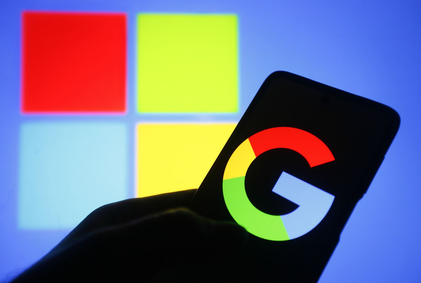 UKRAINE - 2023/02/21: In this photo illustration, a Google logo is seen on a smartphone with a Microsoft logo in the background. (Photo Illustration by Pavlo Gonchar/SOPA Images/LightRocket via Getty Images)