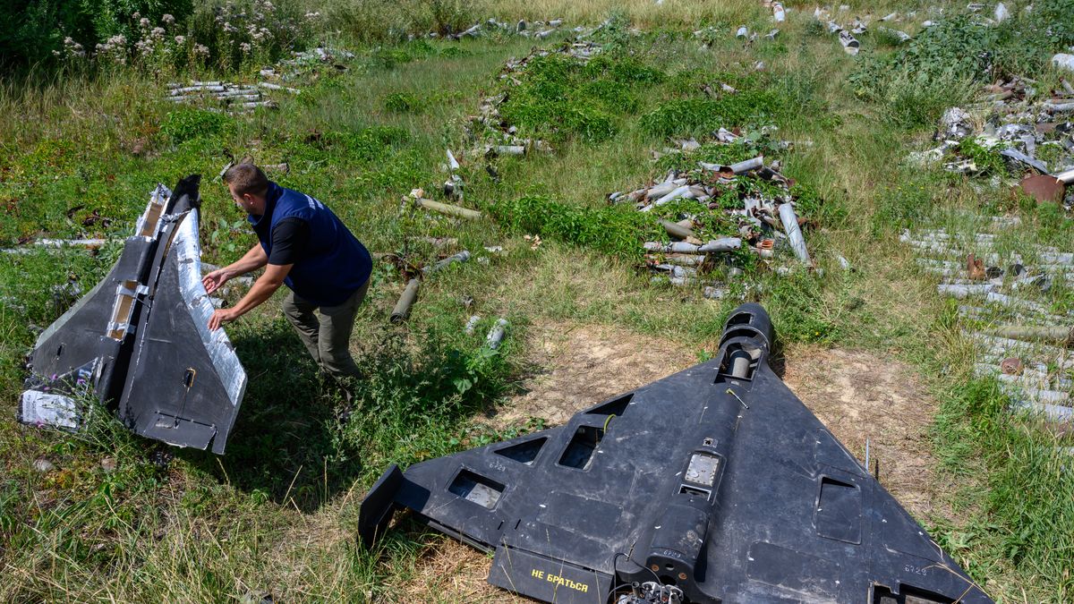 KHARKIV, UKRAINE - JULY 30: Dmytro Chubenko of the Kharkiv regional prosecutor's office holds the remains of a Russian-made, inexpensive decoy drone made of foam and wood, known as a Gerbera, beside an Iran-designed Shahed-136 drone, known as a Geran-2 in Russia, as the prosecutor's office maintains a collection of Russian drones, glide bombs, missiles and rockets launched at Ukraine as evidence for eventual war crimes prosecutions against Russia, on July 30, 2025 in Kharkiv, Ukraine. Russia has intensified missile and drone attacks against Ukraine, firing more than 700 in a single night, often against civilian targets, amidst a surge of daily aerial bombardments of urban centers, 3 1/2 years after Russia's all-out invasion of Ukraine. (Photo by Scott Peterson/Getty Images)