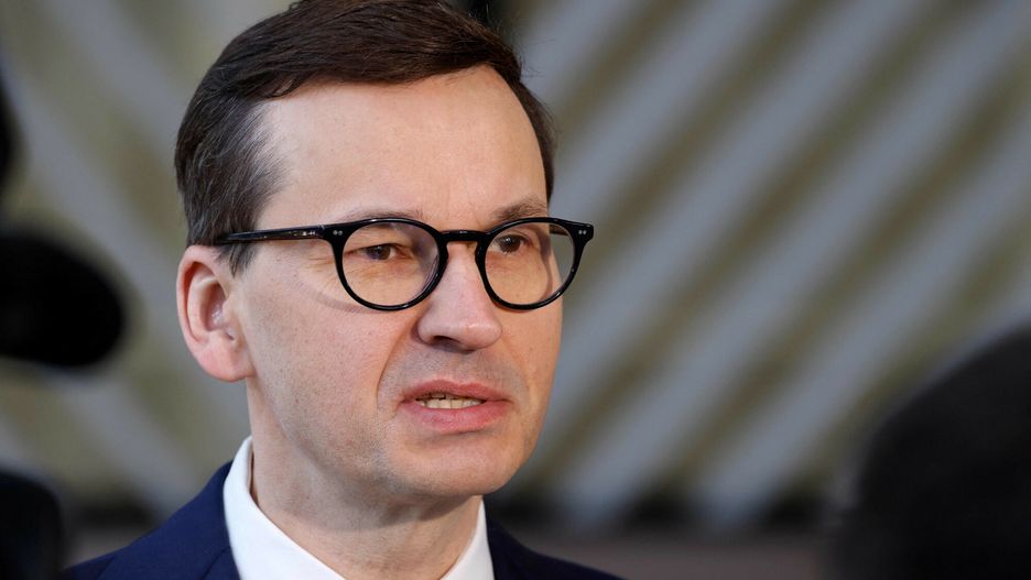 TemporaryPoland's Prime Minister Mateusz Morawiecki talks to the press as he arrives for the second day of a European Union (EU) summit at the EU Headquarters, in Brussels on March 25, 2022. (Photo by Ludovic MARIN / AFP)LUDOVIC MARIN