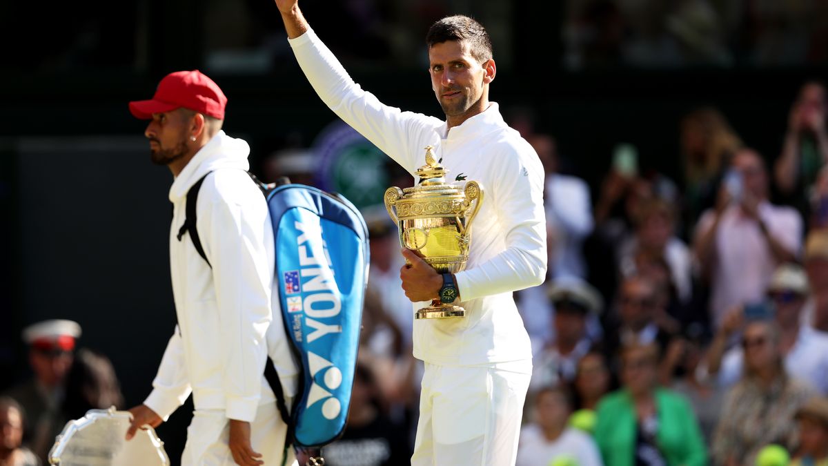 LONDON, ENGLAND - JULY 10: Novak Djokovic of Serbia waves goodbye to the crowd as he walks off court whilst holding the trophy following his victory against Nick Kyrgios of Australia during their Men's Singles Final match on day fourteen of The Championships Wimbledon 2022 at All England Lawn Tennis and Croquet Club on July 10, 2022 in London, England. (Photo by Clive Brunskill/Getty Images)