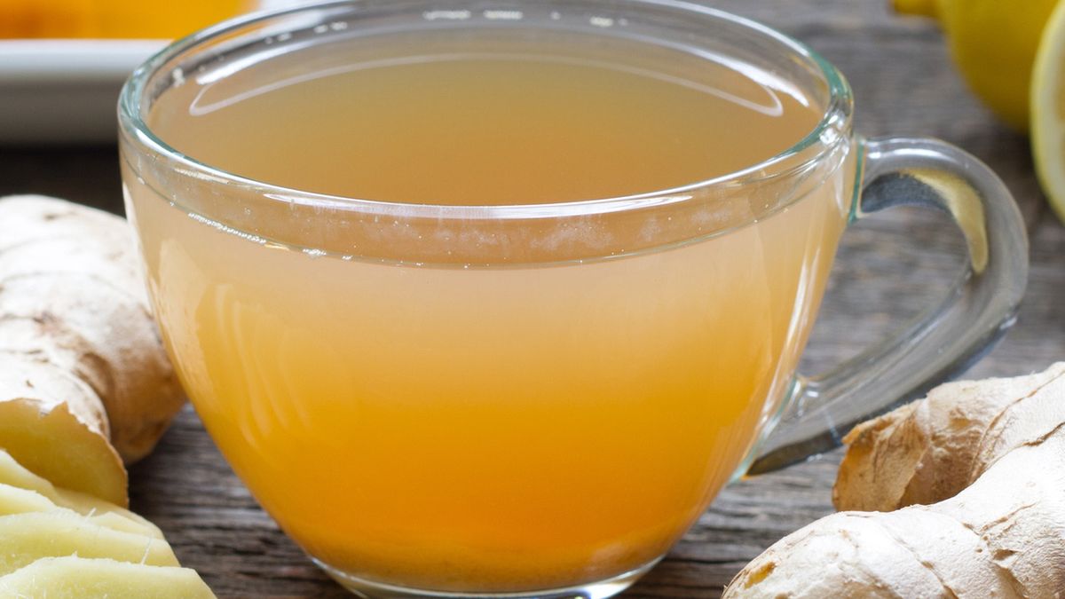 Ginger homemade tea infusion on wooden board with lemonGinger homemade tea infusion on wooden board with lemon still lifeudra