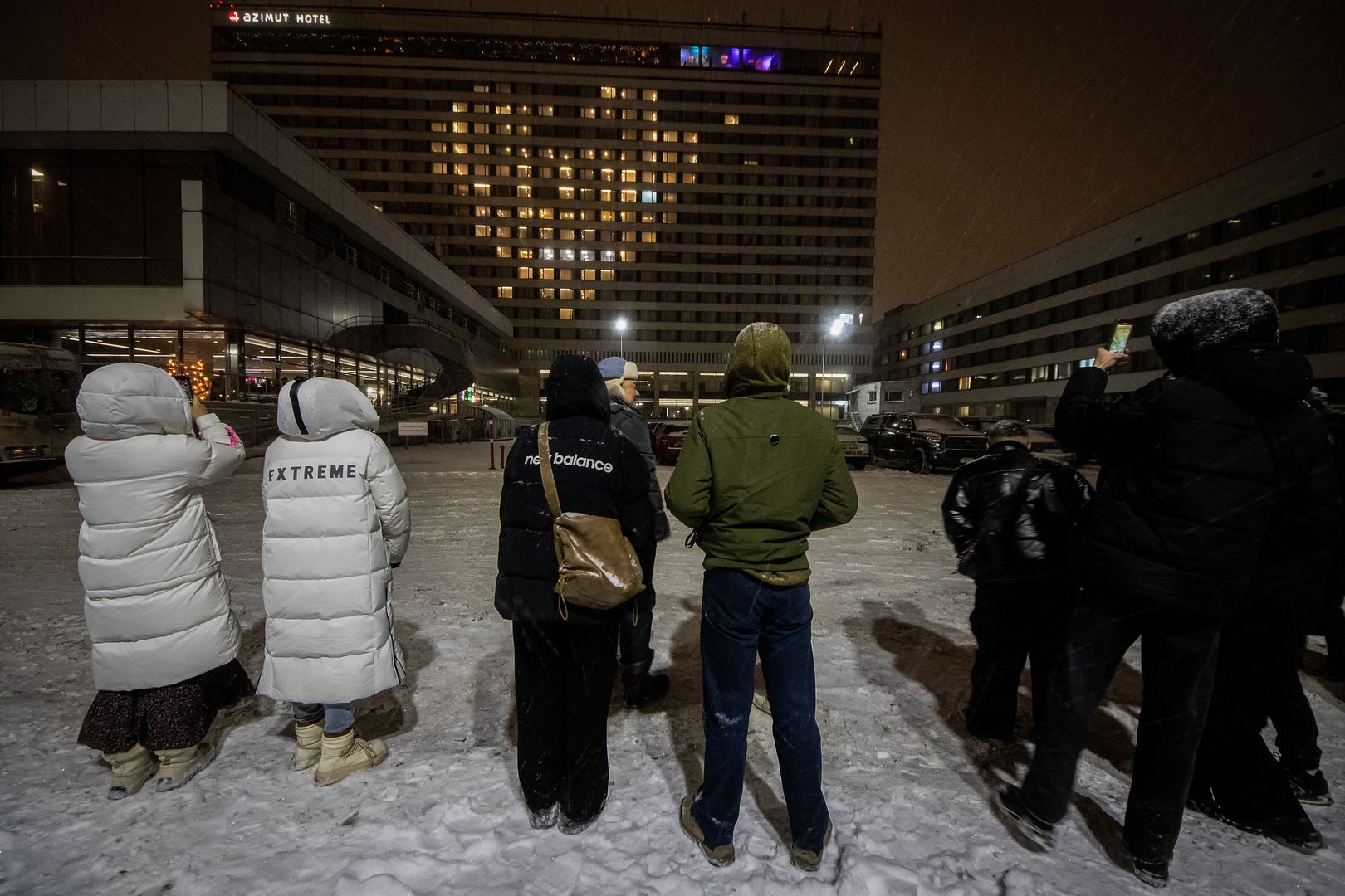 ST  PETERSBURG, RUSSIA - 2024/02/14: People gather on the street, gazing at the Azimut Hotel building adorned with a large heart-shaped illumination during the Valentine's Day celebration on February 14 in St. Petersburg. (Photo by Artem Priakhin/SOPA Images/LightRocket via Getty Images)