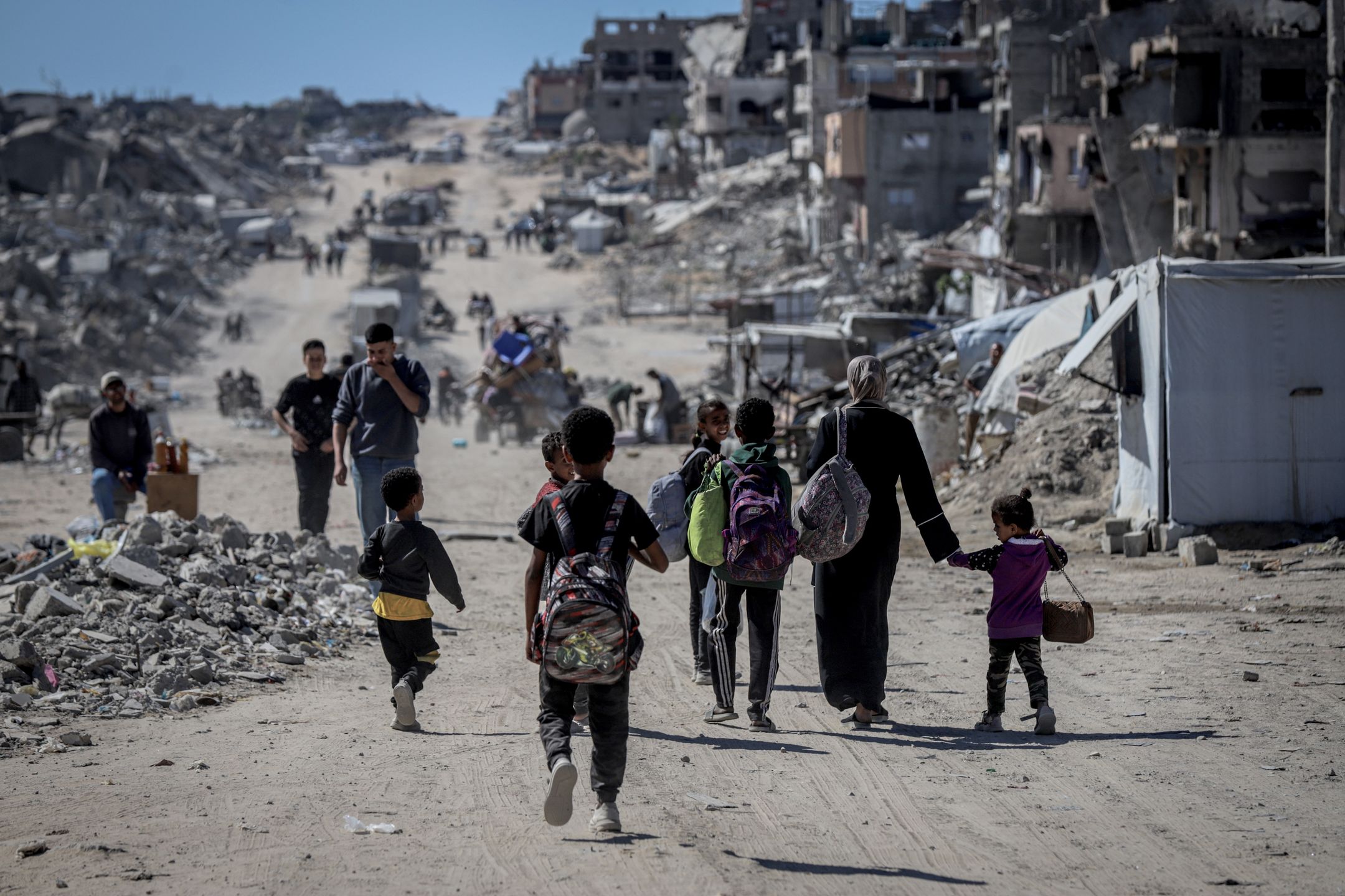 GAZA STRIP - MAY 21: Palestinian residents flee the conflict zones by car, on donkey carts, and on foot, carrying their belongings to safer areas following intense Israeli military attacks on the Jabalia Refugee Camp in northern Gaza on May 21, 2025. (Photo by Saeed M. M. T. Jaras/Anadolu via Getty Images)