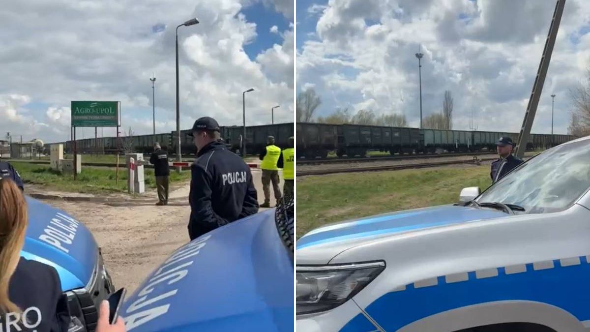Policja pilnująca przejazdu kolejowego przed stacją przeładunkową ukraińskiego zboża