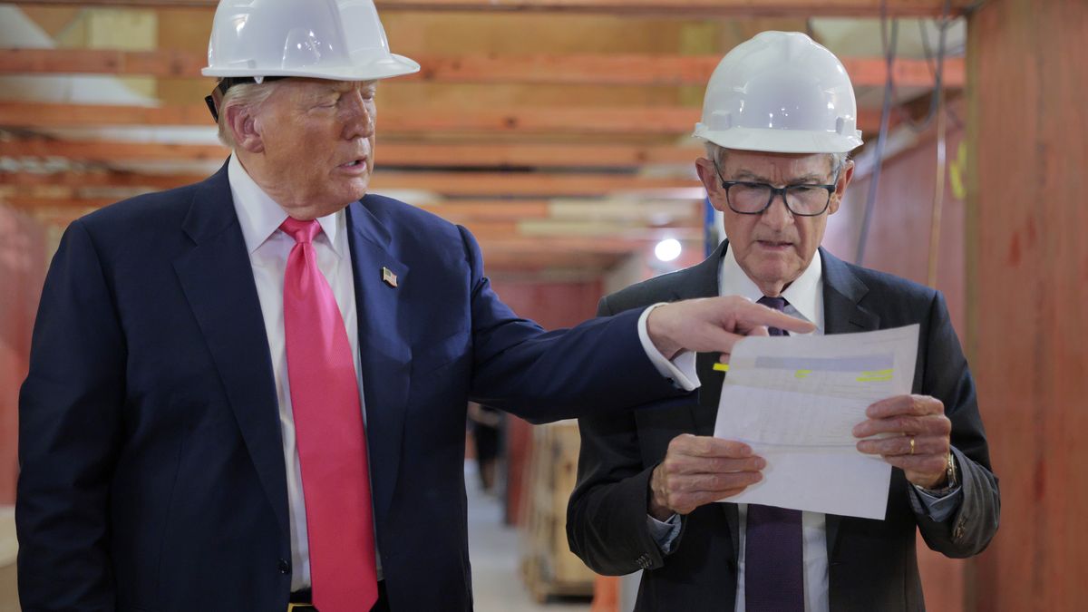 WASHINGTON, DC - JULY 24: U.S. President Donald Trump presents Federal Reserve Chair Jerome Powell with what he Trump called a list of cost overruns for the Federal Reserve’s $2.5 billion headquarters renovation project on July 24, 2025 in Washington, DC. Trump has been critical of the cost of the renovation, blaming Fed Chair Jerome Powell, whom he has called a "numbskull,” for the cost. Trump has recently threatened to oust Powell because, according to the president, the bank has not lowered interest rates fast enough. (Photo by Chip Somodevilla/Getty Images)