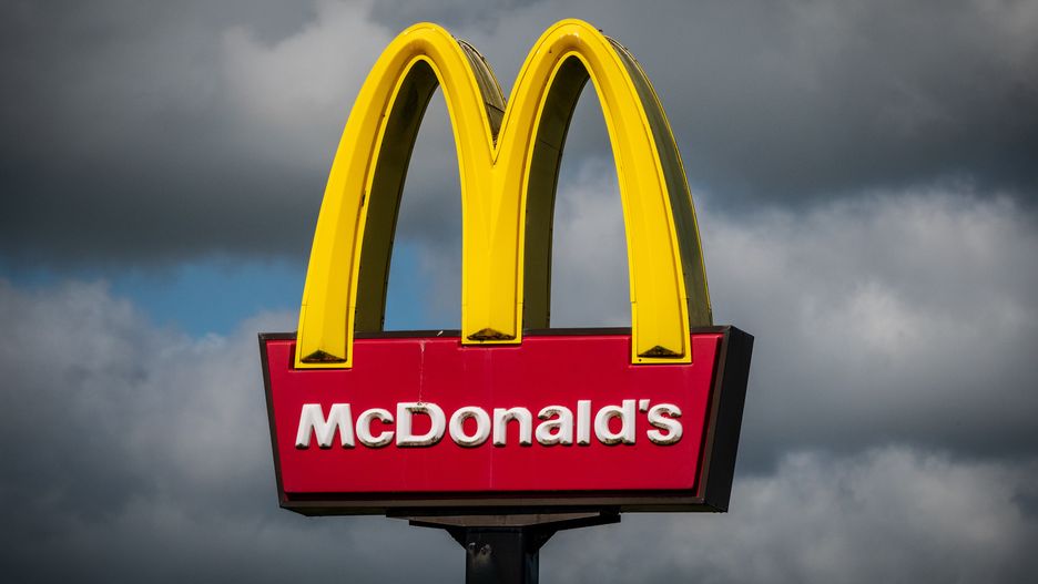 ST AUSTELL, UNITED KINGDOM - AUGUST 14: The sun shines on the yellow Golden Arches logo of the fast food restaurant McDonald's near Saint Austell, on August 14, 2024 in Cornwall, England. Founded in 1940, American multinational fast food chain McDonald's Corporation, best known for its Big Mac hamburgers, cheeseburgers and french fries, is the world's largest fast food restaurant chain.  (Photo by Matt Cardy/Getty Images)