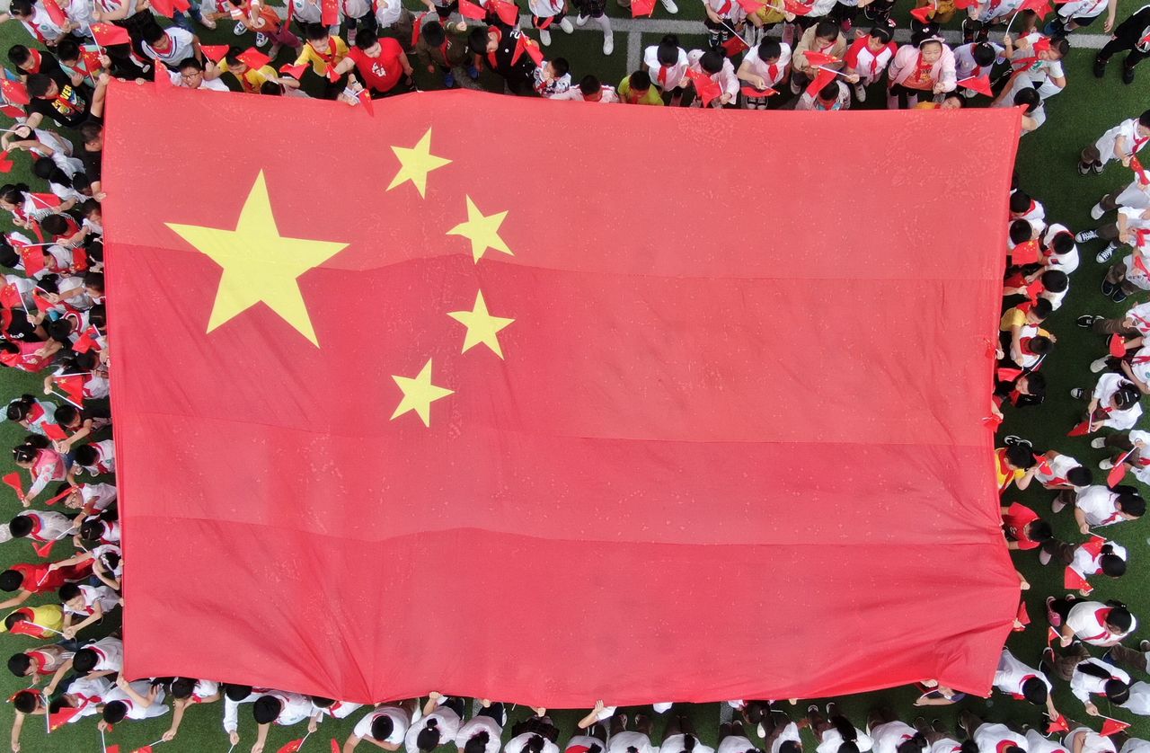 Primary school students hold a five-star red flag and cheer "I love my motherland" in yangzhou, east China's jiangsu province, Sept. 2, 2019.
- PHOTOGRAPH BY Costfoto / Barcroft Media (Photo credit should read Costfoto / Barcroft Media / Barcroft Media via Getty Images)