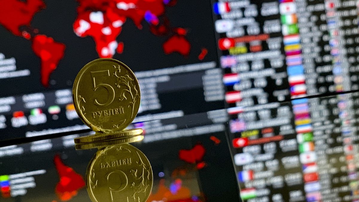 MOSCOW, RUSSIA - MARCH 23: A 5 Russian Ruble coin is seen with a stock market board in back of it on March 23, 2020 in Moscow, Russia. With the decline in oil prices, the Moscow Exchange (MICEX), which has been downward for a while due to the coronavirus (COVID-19) pandemic, fell to 2.234 points with a 4.2 percent loss on the first trading day of the week. And the RTS index decreased by 6.2 percent to 866 points. While concerns about the new type of coronavirus continue in the global markets, the Russian markets started the week with losses with the drop in oil prices. (Photo by Sefa Karacan/Anadolu Agency via Getty Images)