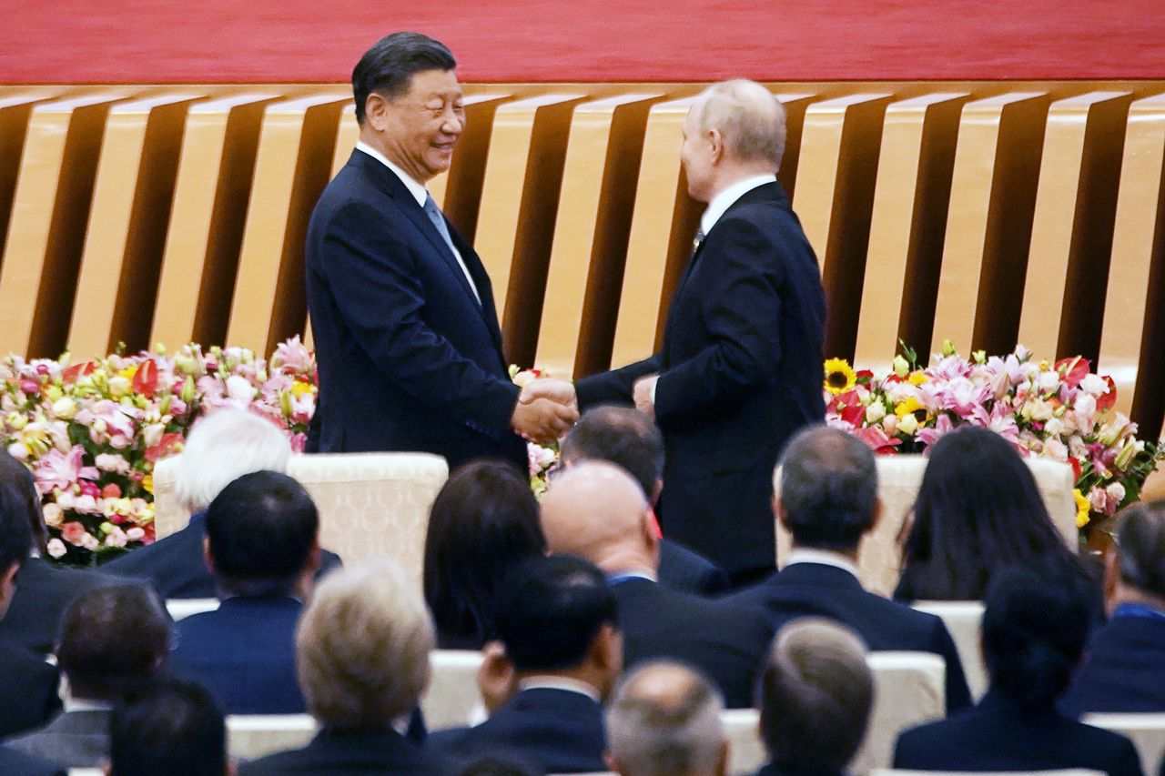 Xi Jinping, China's president, left, shakes hands with Vladimir Putin, Russia's president, during the opening ceremony at the Belt and Road Forum in Beijing, China, on Wednesday, Oct. 18, 2023. Xi said the Belt and Road Initiative has a "golden decade" ahead, welcoming Putin and other delegates at a forum aimed at reinvigorating what Xi has called a "project of the century." Photographer: Qilai Shen/Bloomberg via Getty Images