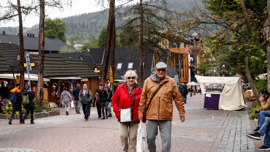 Pensioners walk on a landmark Krupowki Street in the center of Zakopane, a popular Tatra mountain holiday resort as Autumn cold weather starts in Southern Poland on September 17, 2024. As school holidays finished many elderly people and pensioners occupy the resort. (Photo by Dominika Zarzycka/NurPhoto via Getty Images)