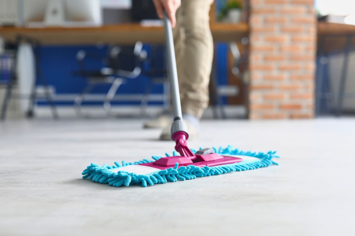 The woman is mopping the floor.