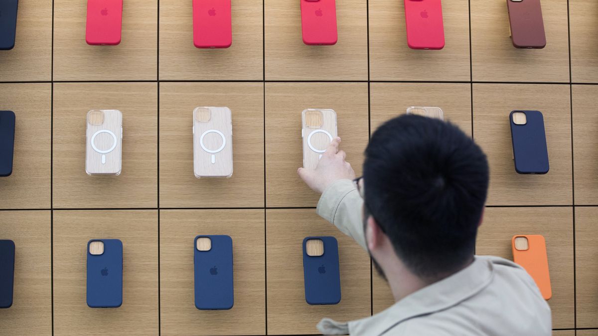 A customer looks at Apple Inc. iPhone MagSafe smartphone cases at an Apple store in Sydney, Australia, on Friday, Sept. 16, 2022. The latest iPhone hits stores today, and Apple is counting on well-heeled shoppers to make the device a hit during a year of roaring inflation and shaky technology spending. Photographer: Brent Lewin/Bloomberg via Getty Images