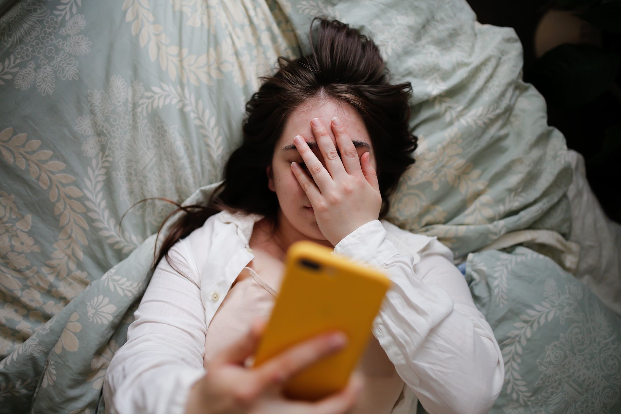 Sleepy overweight young woman with flowing hair using phone on bed, close face palm. Top view
Plus size young woman in home bedroom on bed with phone. Woman covering her eyes with her hand
Natalia  Lebedinskaia