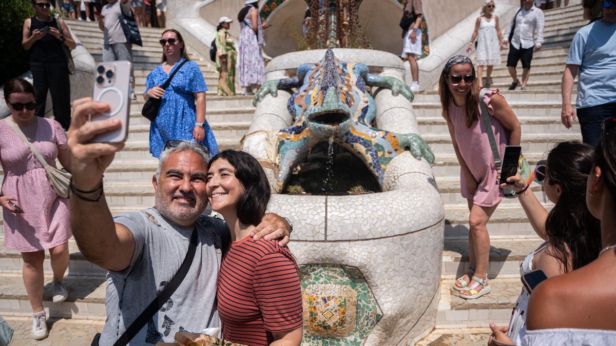 Overtourism At Park Guell In Barcelona.
Tourists stroll through Park Guell and take pictures with Antoni Gaudi's architecture and the famous ''Park Guell Lizard'' during a hot morning in Barcelona, Spain, on July 6, 2025. The Catalan capital receives 20.37 million tourists annually, equivalent to a density of 201,722 visitors per square kilometer, making Barcelona the most crowded and tourist-filled city in the world. (Photo by Marc Asensio/NurPhoto via Getty Images)
NurPhoto
vacation, touristification, asian tourism, itinerary, overcrowding, tour guide, getaway, world, heritage, historical interest, trip, mobile, destination, mass tourism, china, la salut neighborhood, heat, barcelona