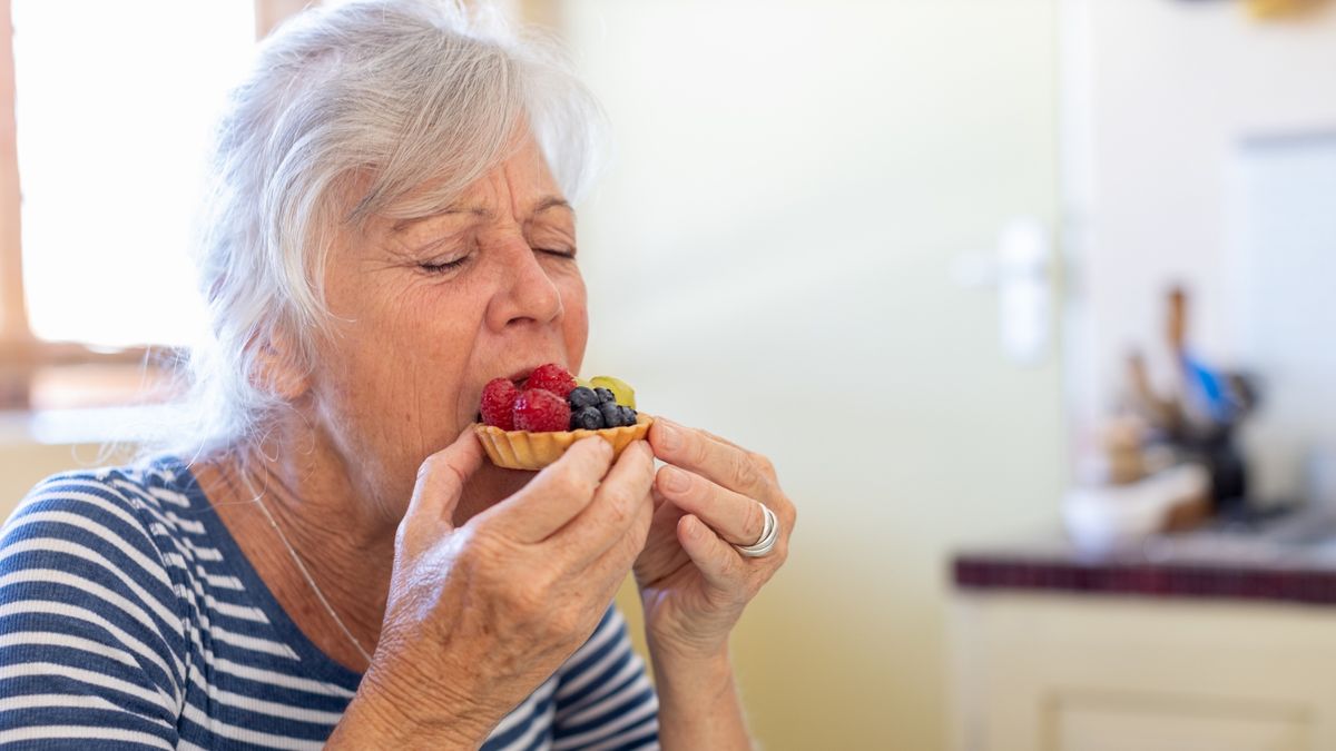 Senior woman enjoying eating a fruit tart
Alistair Berg