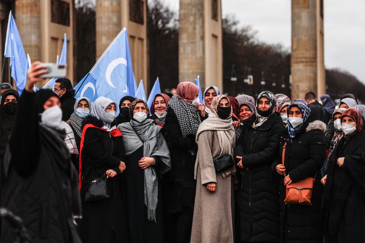 Uyghur women attend a demonstration against Beijing 2022 Winter Olympic Games in Berlin, Germany, 04 January 2022