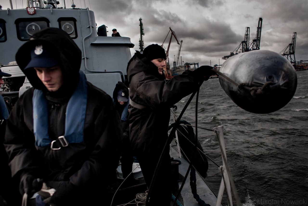 Żołnierze Marynarki Wojennej przygotowują się do zacumowania w porcie MW w Gdyni, 2012 r.