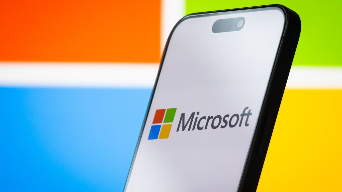 CHONGQING, CHINA - APRIL 26: In this photo illustration, the logo of Microsoft Corporation is displayed on a smartphone screen, with the company's colorful branding visible in the background, on April 26, 2025, in Chongqing, China. Microsoft is a leading American multinational technology company, known for its Windows operating system, Microsoft Office software suite, Azure cloud services, and other enterprise and consumer technology products. (Photo illustration by Cheng Xin/Getty Images)