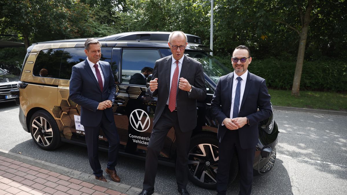 HANOVER, GERMANY - JULY 22: Federal Chancellor Friedrich Merz (center, CDU) and Lower Saxony's Minister-President Olaf Lies (left, SPD) stand with Christian Senger, CEO of Volkswagen Autonomous Mobility, in front of a VW ID.Buzz on July 22, 2025 in Hanover, Germany. Volkswagen presented the technology of autonomous driving to both of them using a VW ID.Buzz. (Photo by Moritz Frankenberg - Pool/Getty Images)