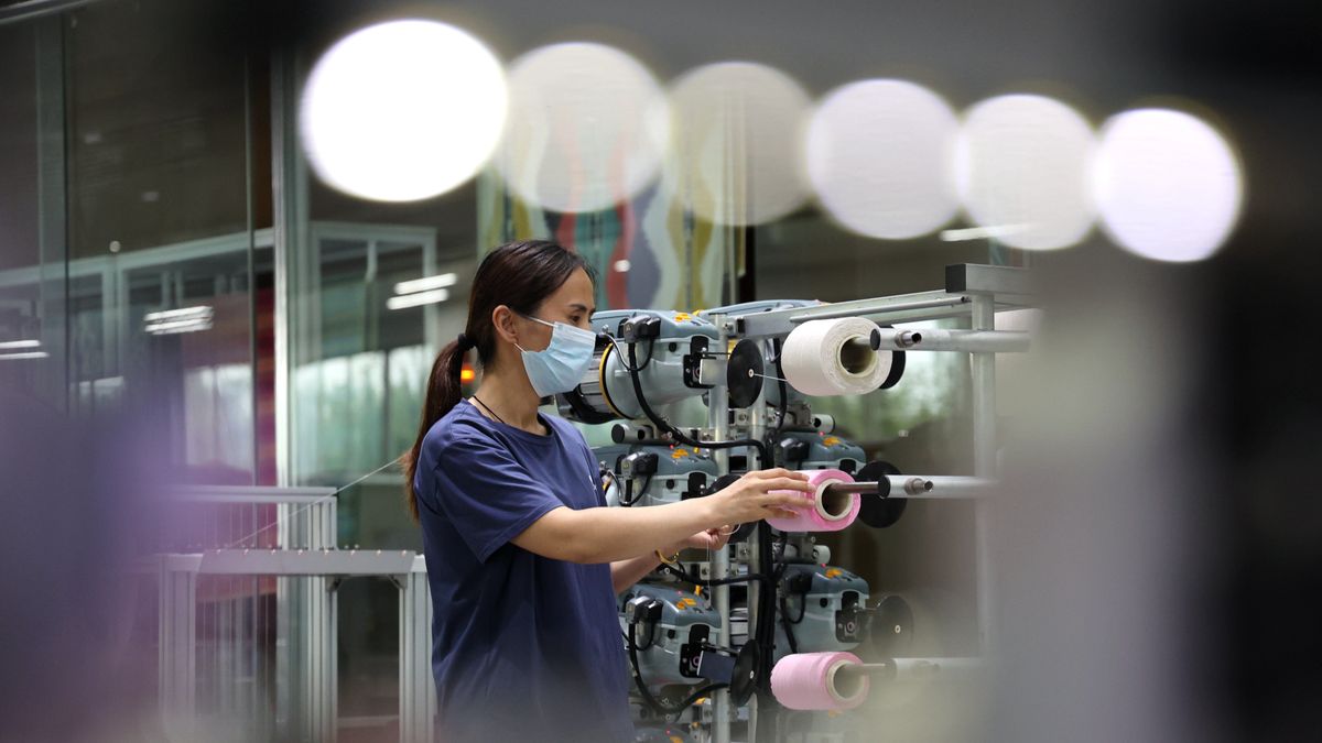 A worker is making towels for overseas orders at a workshop of a towel manufacturer in Bincheng District, Binzhou city, East China's Shandong province, on July 2, 2024. On July 15, 2024, the data released by the National Bureau of Statistics shows that after preliminary calculation, the gross domestic product (GDP) in the first half of the year is 61,683.6 billion yuan, an increase of 5.0% at constant prices. (Photo by Costfoto/NurPhoto via Getty Images)