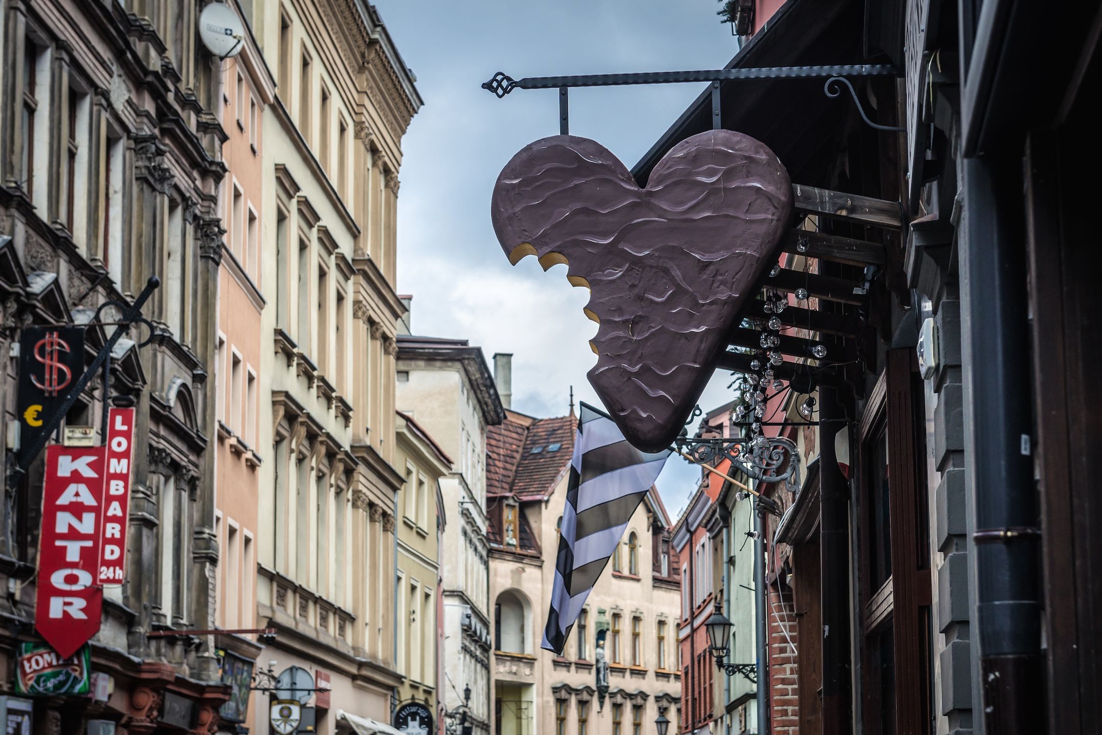 Torun, Poland - February 20, 2019: Gingerbread sign over the entrance of sweet shop in historic part of TorunTorun, gingerbread, gingerbreads, Old Town, Old City, Poland, shop, store, sweet, sweets, Polish, city, urban, sign, signboard, travel, tourism, tourist attraction, travel destination, confectionery, confectioners, cake shop, landmark, building, famous, sightseeing, Kuyavian, Cuiavian, Pomeranian, Voivodeship, Province, Kujawsko Pomorskie, Kujawy Pomerania, Europe, old, historic, historical, history, Stare Miasto, UNESCO, World Heritage Site, torun, gingerbread, gingerbreads, old town, old city, poland, shop, store, sweet, sweets, polish, city, urban, sign, signboard, travel, tourism, tourist attraction, travel destination, confectionery, confectioners, cake shop, landmark, building, famous, sightseeing, kuyavian, cuiavian, pomeranian, voivodeship, province, kujawsko pomorskie, kujawy pomerania, europe, old, historic, historical, history, stare miasto, unesco, world heritage site