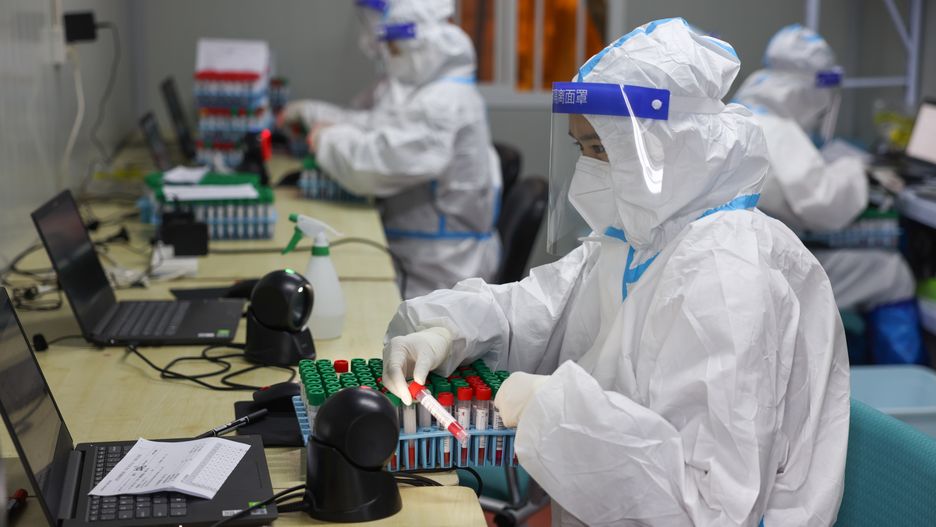 SHANGHAI, CHINA - APRIL 15: Medical workers work inside Nucleus Huaxi Medical Laboratory for COVID-19 testing at a sports center in Pudong New Area on April 15, 2022 in Shanghai, China. (Photo by VCG/VCG via Getty Images)