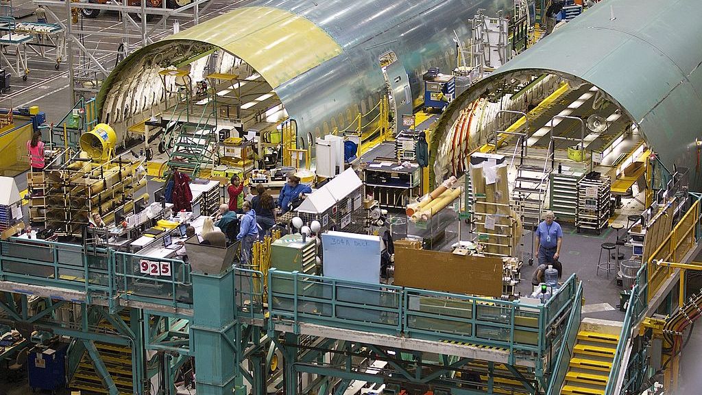 Boeing's Everett Plant Continues Assembly Of 777 And 787 Widebody Jets
EVERETT, WA - FEBRUARY 14: Boeing employees work on Boeing 777 passenger plane fuselage section on one of the assembly lines February 14, 2011 at the company's factory in Everett, Washington.  The new plane features quieter, more fuel efficient engines, more seating and a redesigned interior. The first plane also featured a red paint job, a departure from the traditional Boeing blue. (Photo by Stephen Brashear/Getty Images)
Stephen Brashear
airplane, assembly, aviation, design, economy, efficiency, factory, innovation, jet, jobs, labor, manufacture, manufacturing, technology