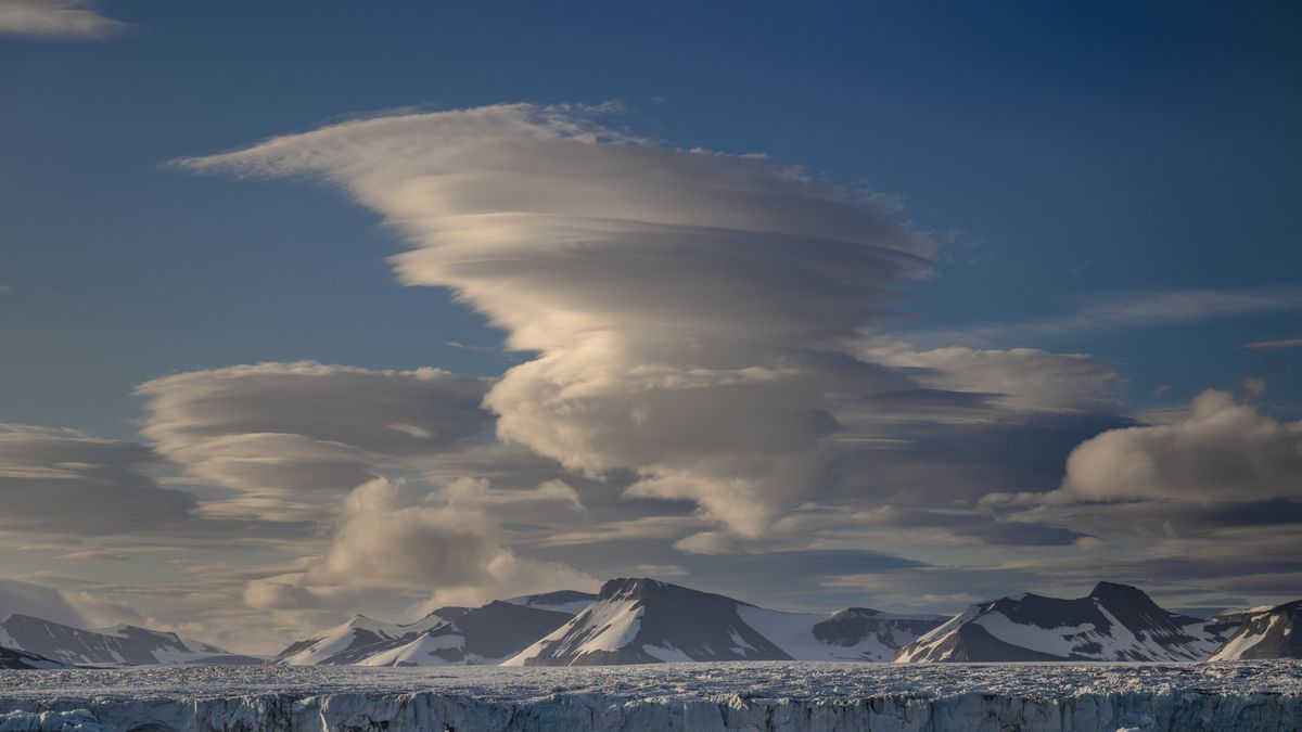 SVALBARD AND JAN MAYEN, NORWAY - JULY 24: Lenticular clouds appear over the glaciers during the 5th National Arctic Scientific Research Expedition  near Svalbard and Jan Mayen on July 24, 2025. Turkish scientists conducted scientific research expeditions in the North Pole and the South Pole, making observations and measurements of the atmosphere and ocean systems. During the 5th National Arctic Scientific Research Expedition, conducted under the auspices of the Turkish Presidency, the responsibility of the Turkish Industry and Technology Ministry, and the coordination of the TUBITAK MAM Polar Research Institute, research teams conducted extensive scientific data collection studies extending from the atmosphere to the depths of the sea. (Photo by Sebnem Coskun/Anadolu via Getty Images)