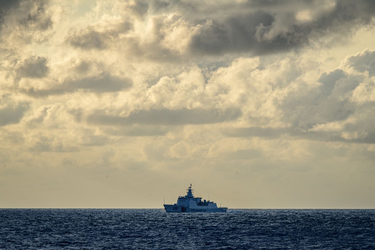 WEST PHILIPPINE SEA, PHILIPPINES - DECEMBER 10: A China coast guard vessel sails near the Filipino ship on a resupply mission to the communities and Filipino military personnel stationed in the Spratlys, on December 10, 2023, in Palawan, Philippines. Escorted by Philippine Coast Guard ships, civil society and fishing community gathered in El Nido town to embark on a civilian-led resupply and gift mission to residents and military personnel stationed in the far flung islands in the contested area of the Spratlys group of islands as Christmas nears. The mission was cut short as China navy and coast guard ships present in the area prompted the captain of the Filipino supply boat to turn back, against the assurance of the Philippine Coast Guard to push through. China cost guard ships earlier fired water cannons and rammed another civilian boat performing resupply missions to Ayungin Shoal and a government fisheries boat in Scarborough shoal. The Philippines, the only predominantly Christian nation in South East Asia, has been celebrating Christmas for more than 400 years. (Photo by Jes Aznar/Getty Images)