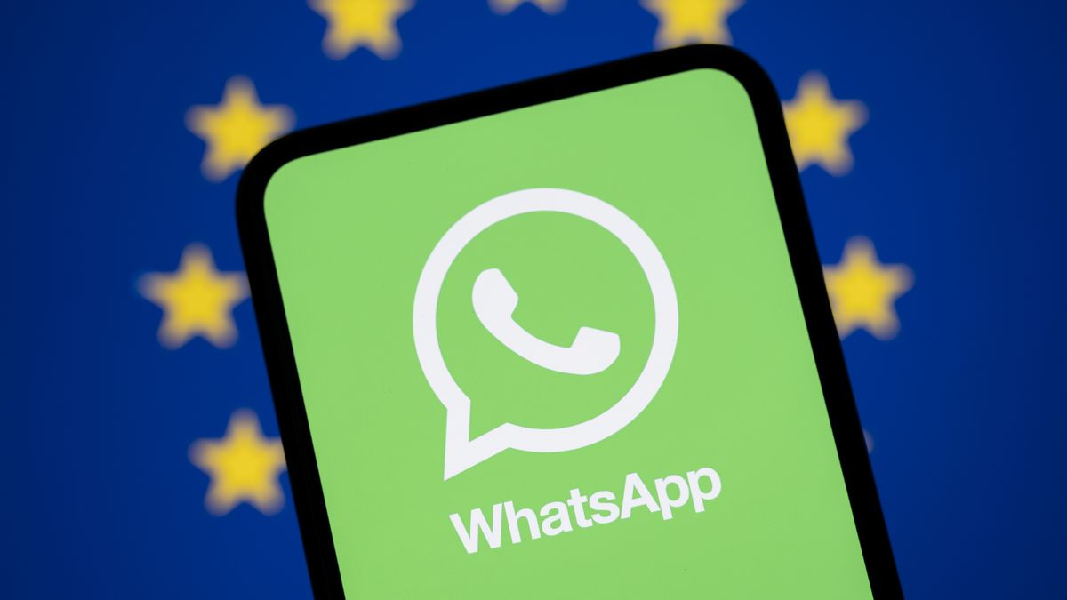 The WhatsApp logo appears on a smartphone screen with a European Union (EU) flag in the background. The European Commission formally accuses Meta of abusing its dominant market position through its WhatsApp messaging service by excluding competing Artificial Intelligence (AI) assistants and considers activating emergency interim measures in Creteil, France, on February 10, 2026. (Photo by Samuel Boivin/NurPhoto via Getty Images)