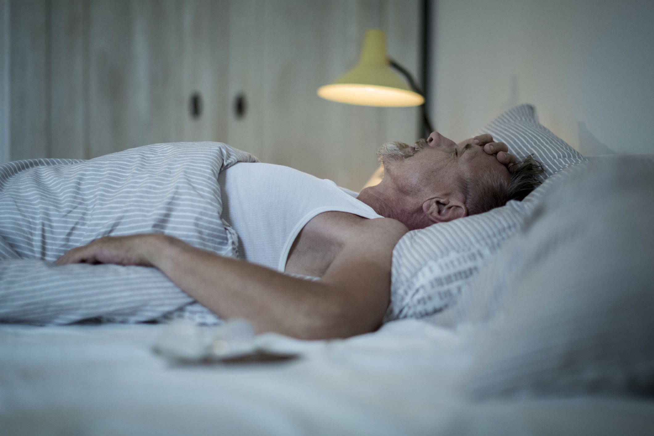 Senior man in his early 60s with greying beard is sick and sleepless in bed while night.
EMS-FORSTER-PRODUCTIONS
megrim, migraine, bad dream, sickness