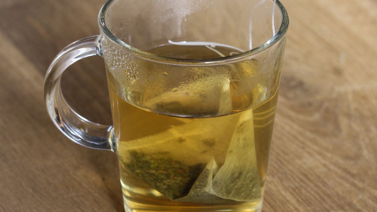 glass of green tea with tea bag on wooden backgroundClose up of cup of green tea on wooden tablemichael meijergreen, tea, glass, beverage, healthy, hot, background, teacup, fresh, health, white, isolated, aroma, object, herbal, closeup, heat, nobody, chinese, natural, wooden, cup of tea, mint, diet, dishware