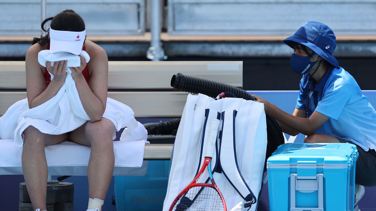 TOKYO, JAPAN - JULY 24: Nao Hibino of Team Japan attempts to cool down between games during her Women's Singles First Round match against Nina Stojanovic of Team Serbia on day one of the Tokyo 2020 Olympic Games at Ariake Tennis Park on July 24, 2021 in Tokyo, Japan. (Photo by Clive Brunskill/Getty Images)