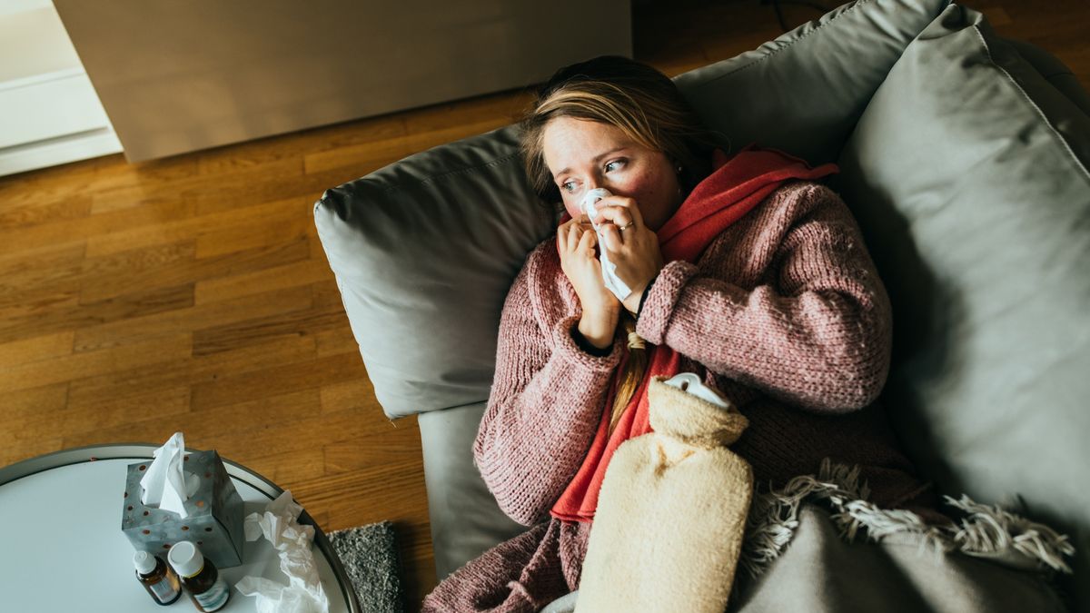 Woman lying on a sofa while having a flu and feeling sick and sneezing.
Woman lying on a sofa while having a flu and feeling sick.She using a heat pillow for her stomage and a bit of medicine standing on the table.
Guido Mieth